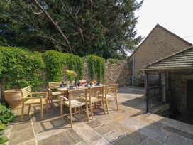 An outdoor dining area with a table and chairs at Easter Cottage in Burford