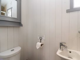 A bathroom with a sink and toilet at The Shepherds Hut in Chippenham