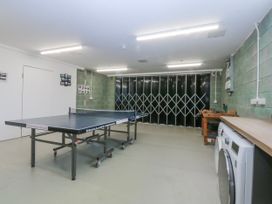 A games room with a ping pong table and washing machine at Bwthyn Alberts in Trearddur Bay