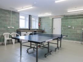 A games room with a ping pong table and washing machines at Bwthyn Alberts in Trearddur Bay