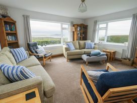 A living room with sofas and bookshelf at Yr Orsedd in Llanfaethlu