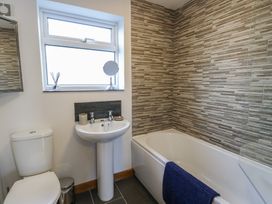 A bathroom with a sink, toilet, and bathtub at Yr Orsedd in Llanfaethlu
