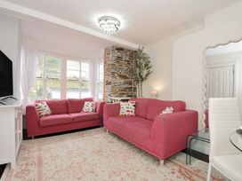 A living room with a sofa and television at Stargazy in Trebarwith Strand near Tintagel
