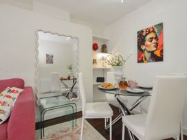 A dining room with a table and chairs at Stargazy in Trebarwith Strand near Tintagel