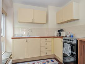 A kitchen with cabinets and appliances at Stargazy Trebarwith Strand near Tintagel