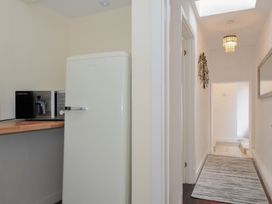 A kitchen with a refrigerator and microwave at Stargazy in Trebarwith Strand near Tintagel