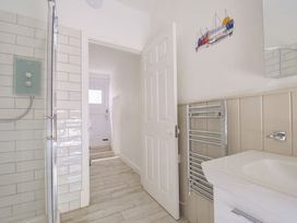 A bathroom with shower and towel rail at Stargazy in Trebarwith Strand near Tintagel