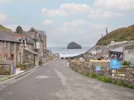 A street view with buildings and ocean in the background at Stargazy near Trebarwith Strand Tintagel