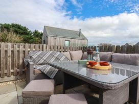 An outdoor seating area with a table and couch at Idlewild, 2 Wheal Turnavore, St Agnes