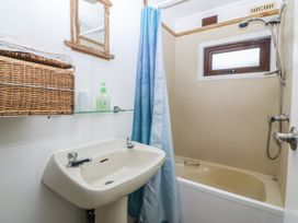 A bathroom with a sink and bathtub at Castell Chalet Penrhos near Pwllheli