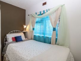 A bedroom with a bed and a window at Castell Chalet Penrhos near Pwllheli