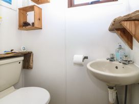 A bathroom with a toilet and sink at Castell Chalet Penrhos near Pwllheli