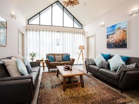 A living room with sofas and a coffee table at Cowslip in Bamburgh