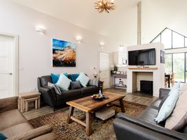 A living room with sofas and a television at Cowslip in Bamburgh