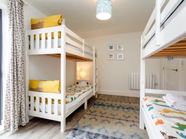 A bedroom with bunk beds and a lamp at Cowslip in Bamburgh