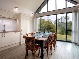 A dining room with a table and chairs at Cowslip in Bamburgh