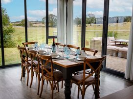 A dining room with a table set for dinner at Cowslip in Bamburgh
