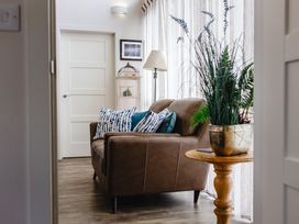 A living room with a sofa and cushions at Betony in Bamburgh