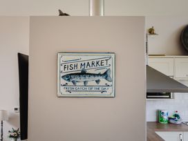 A kitchen with a fish market sign and kitchen appliances at Betony in Bamburgh