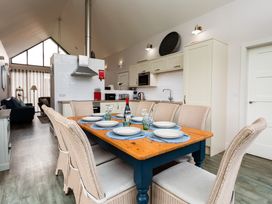 A dining room with a wooden table and chairs at Betony in Bamburgh