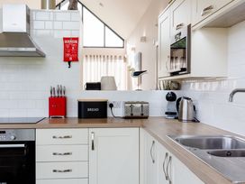 A kitchen with a sink, oven, and kitchen appliances at Betony in Bamburgh