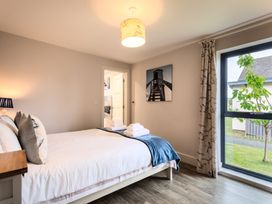 A bedroom with a bed and a window at Betony in Bamburgh