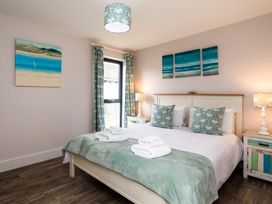 A bedroom with a double bed and wall art at Betony in Bamburgh