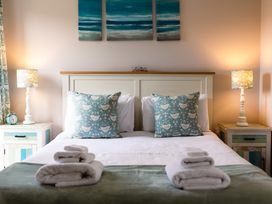 A bedroom with bed, pillows, and lamps at Betony in Bamburgh