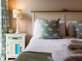 A bedroom with a bed and nightstand at Betony in Bamburgh