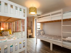 A bedroom with bunk beds and a dresser at Betony Bamburgh