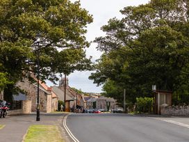 A street view with trees and buildings at Betony in Bamburgh
