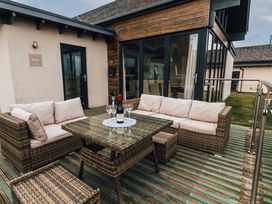 An outdoor seating area with a table and couch at Betony in Bamburgh