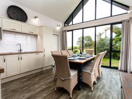 A kitchen with a dining table and chairs at Betony in Bamburgh