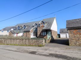 A house with a garage and driveway at Sunflower Cottage St Issey
