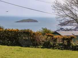 A coastal view with an island in the sea at Pen Y Garth Mynytho near Llanbedrog