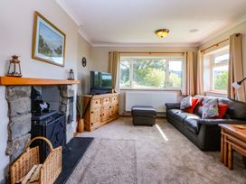A living room with a sofa and television at Pen Y Garth, Mynytho near Llanbedrog