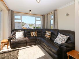 A snug with a leather sofa and coffee table at Pen Y Garth Mynytho near Llanbedrog