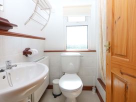 A bathroom with a toilet and sink at Pen Y Garth in Mynytho near Llanbedrog