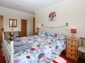A bedroom with a bed and furniture at Pen Y Garth in Mynytho near Llanbedrog