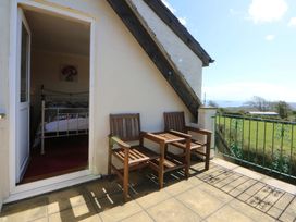 A balcony with chairs and a view at Pen Y Garth in Mynytho near Llanbedrog