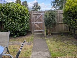 A garden with a gate and plants at Troopers Cottage in Frome