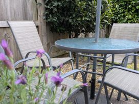 A table with chairs in a garden at Troopers Cottage in Frome