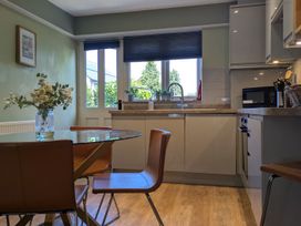 A kitchen with a dining table and chairs at Troopers Cottage in Frome