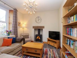 A living room with furniture and a fireplace at Holcombe House in Torquay