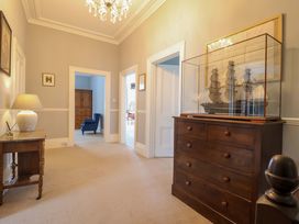 A hallway with a model ship and lamp at Holcombe House in Torquay