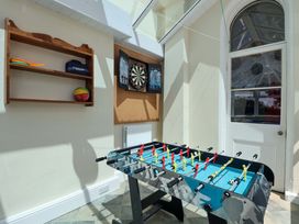 A games room with a foosball table and dartboard at Holcombe House in Torquay
