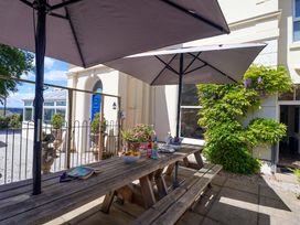 An outdoor area with a table and beverages at Holcombe House in Torquay