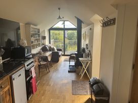 A kitchen with a sofa and dining area at The Hideout in Llangrove