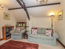 A living room with a sofa and armchairs at The Coach House in Kingston