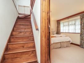 A bedroom with a bed and stairs at The Coach House in Kingston